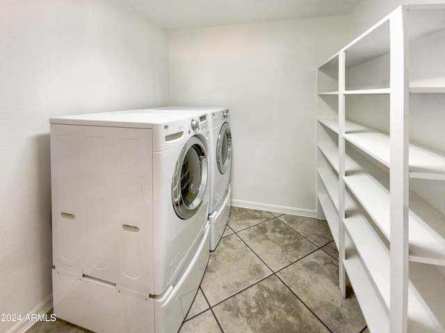 clothes washing area featuring washer and dryer and light tile patterned flooring