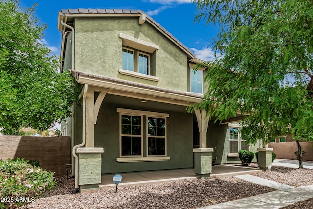 1915 S Ponderosa Dr, Gilbert, AZ 85295 - view of front of house featuring stucco siding, fence, and a porch