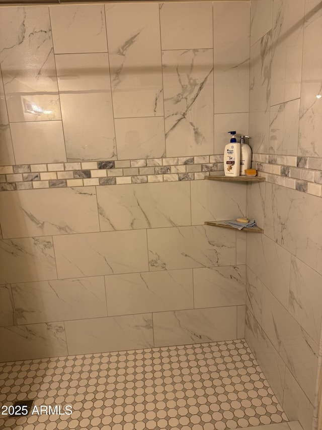 bathroom with a tile shower