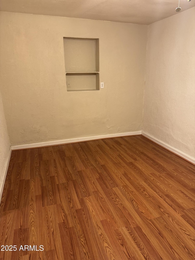 spare room with hardwood / wood-style flooring