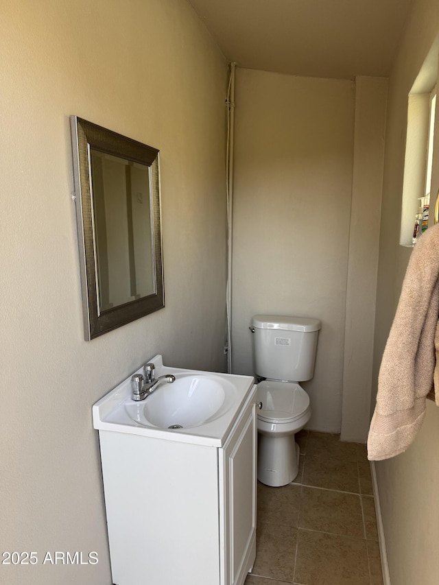 bathroom featuring vanity, tile patterned floors, and toilet