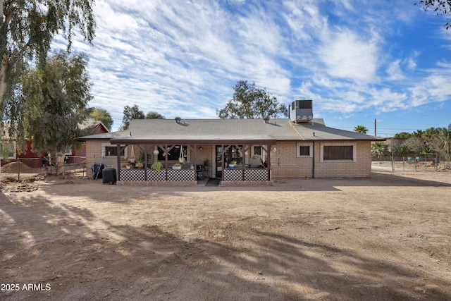 26415 S Recker Rd, Queen Creek, AZ 85142 - back of house featuring brick siding, central air condition unit, fence, and a porch