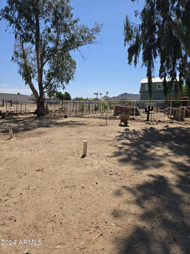 view of yard featuring a rural view and fence