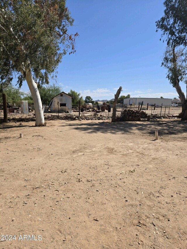 view of yard featuring a rural view and fence