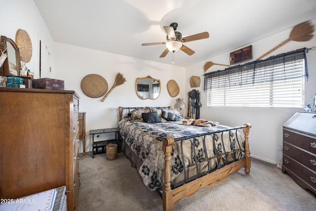 carpeted bedroom featuring ceiling fan and baseboards