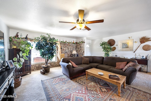 living room featuring a healthy amount of sunlight, a textured ceiling, a ceiling fan, and carpet flooring