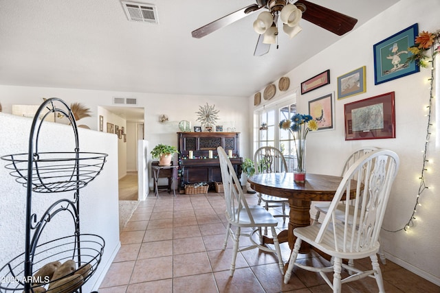 dining area featuring light tile patterned floors, baseboards, visible vents, and ceiling fan