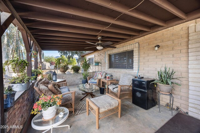 view of patio featuring a ceiling fan and an outdoor living space