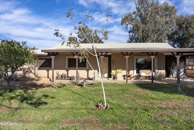 exterior space with a front lawn and a patio area