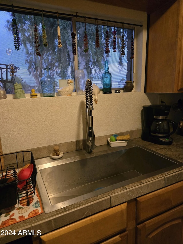 details with a textured wall and a sink