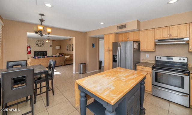 kitchen featuring under cabinet range hood, stainless steel appliances, visible vents, and light brown cabinets