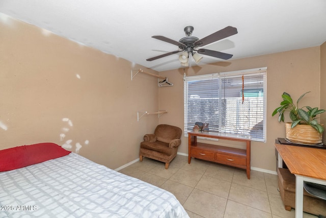 bedroom featuring baseboards, ceiling fan, and light tile patterned flooring