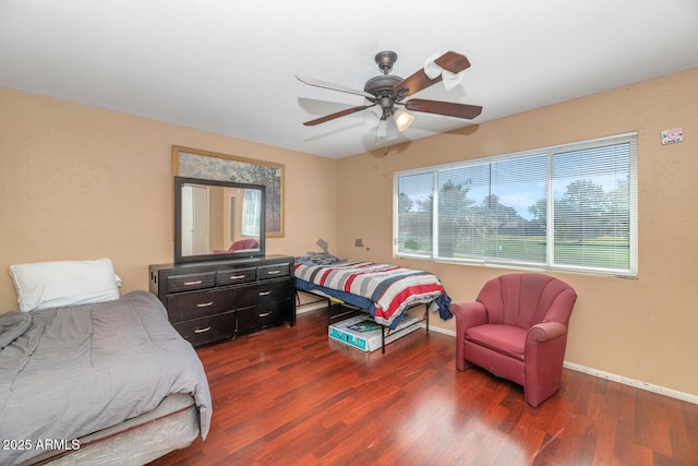 bedroom with baseboards, ceiling fan, and wood finished floors