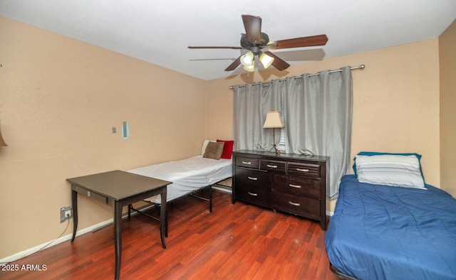 bedroom with baseboards, ceiling fan, and dark wood-style flooring
