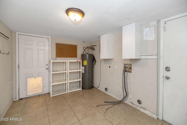 laundry room featuring cabinet space, light tile patterned flooring, hookup for a washing machine, water heater, and electric dryer hookup