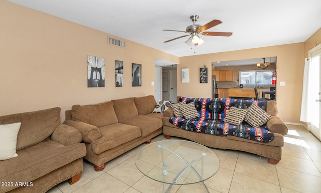tiled living room with ceiling fan and visible vents