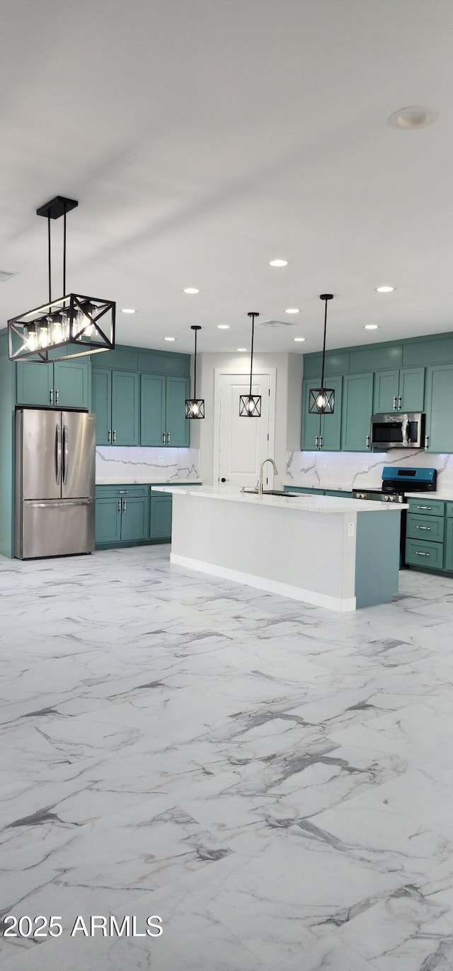 kitchen featuring pendant lighting, stainless steel appliances, sink, and decorative backsplash