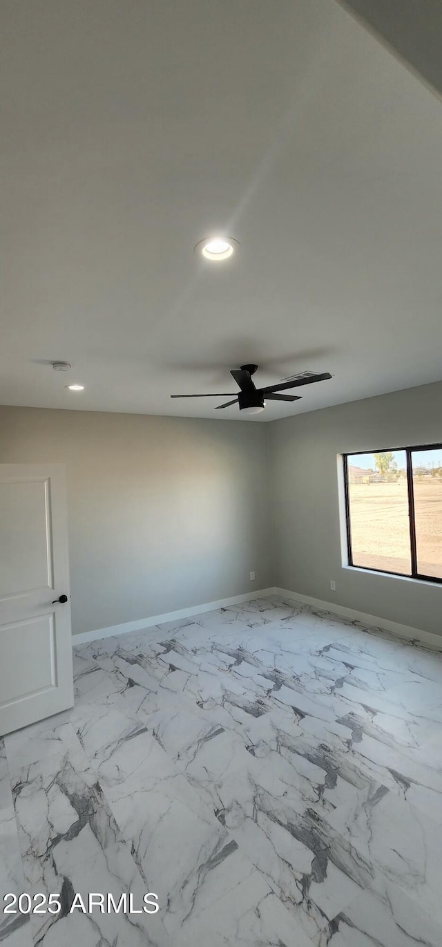 spare room with ceiling fan