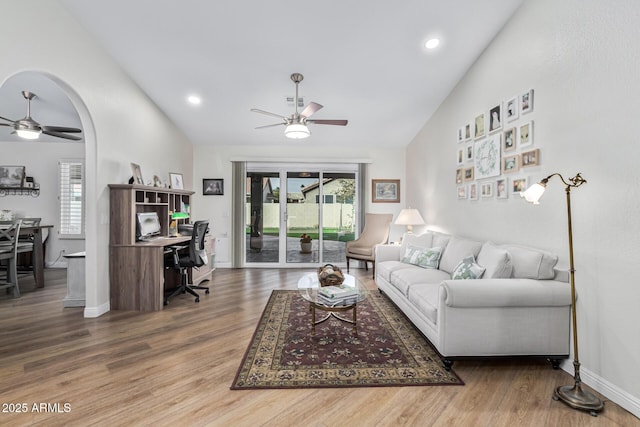 living room with vaulted ceiling, hardwood / wood-style floors, and ceiling fan