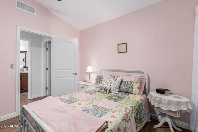 bedroom featuring lofted ceiling and dark wood-type flooring