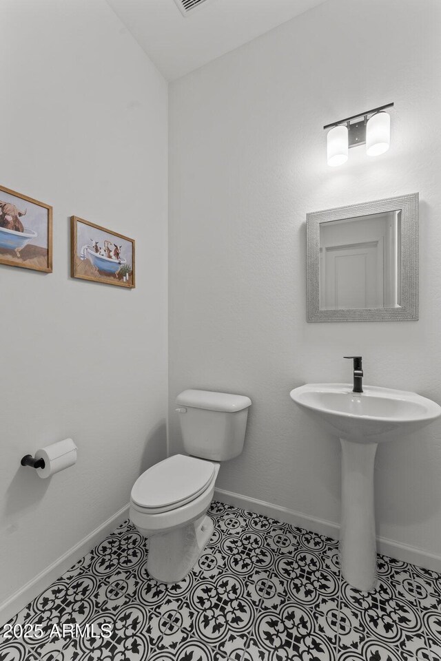 bathroom featuring tile patterned flooring, sink, and toilet