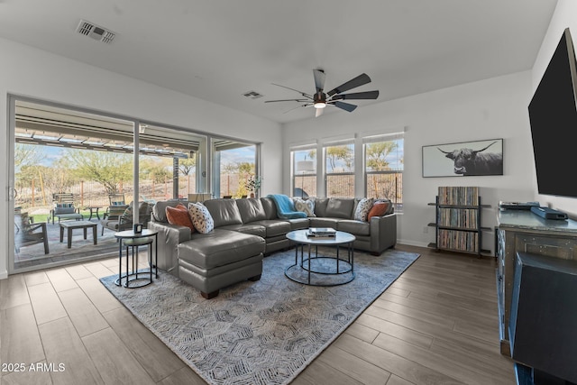 living room featuring hardwood / wood-style flooring and ceiling fan