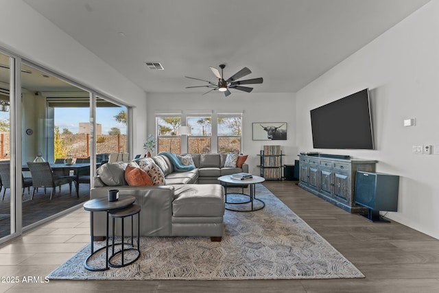 living room with hardwood / wood-style floors, a wealth of natural light, and ceiling fan