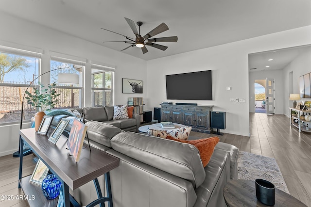 living room featuring ceiling fan and light wood-type flooring