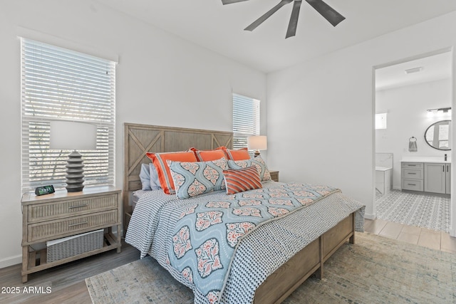 bedroom featuring ceiling fan, wood-type flooring, and ensuite bath