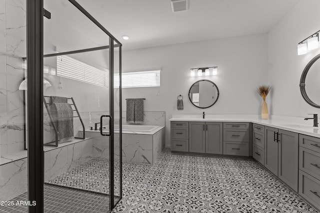 bathroom featuring shower with separate bathtub and vanity