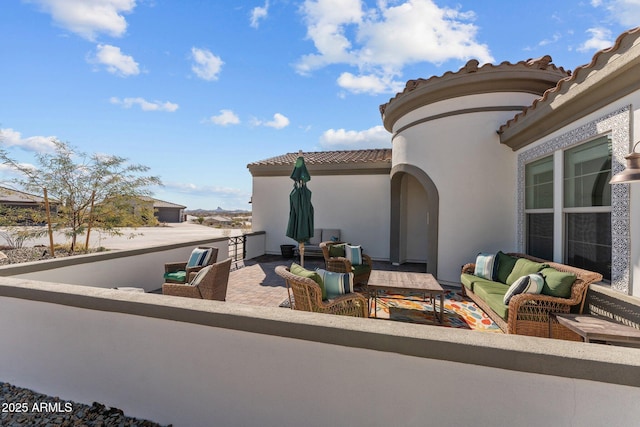 view of patio with a balcony and an outdoor living space