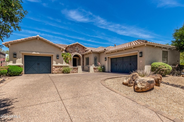 3824 E Parkside Ln, Phoenix, AZ 85050 - mediterranean / spanish-style house with concrete driveway, an attached garage, stucco siding, stone siding, and a tile roof
