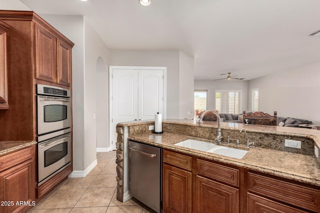 3824 E Parkside Ln, Phoenix, AZ 85050 - kitchen featuring stainless steel appliances, a sink, light stone countertops, ceiling fan, and open floor plan