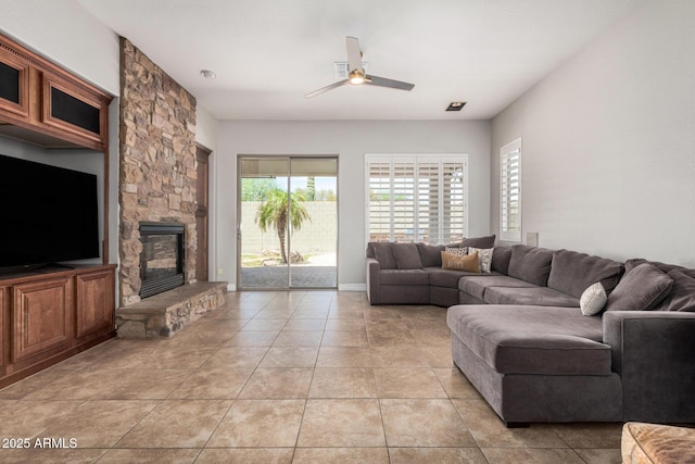 3824 E Parkside Ln, Phoenix, AZ 85050 - living room with a ceiling fan, light tile patterned floors, and a stone fireplace