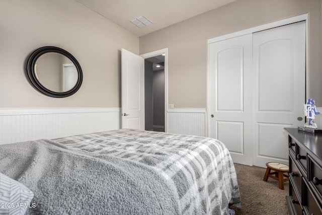 3824 E Parkside Ln, Phoenix, AZ 85050 - bedroom with wainscoting, carpet, and a closet