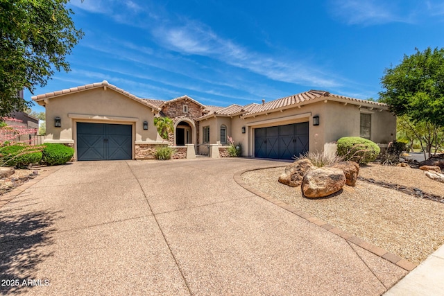3824 E Parkside Ln, Phoenix, AZ 85050 - mediterranean / spanish-style home with a garage, concrete driveway, stucco siding, a tiled roof, and stone siding