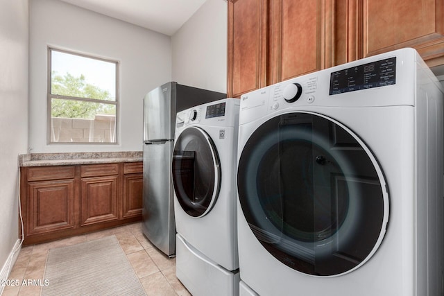 3824 E Parkside Ln, Phoenix, AZ 85050 - laundry room featuring cabinet space, washer and clothes dryer, and light tile patterned floors