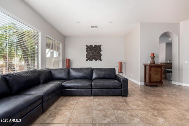 3824 E Parkside Ln, Phoenix, AZ 85050 - living area featuring arched walkways, baseboards, and light tile patterned flooring