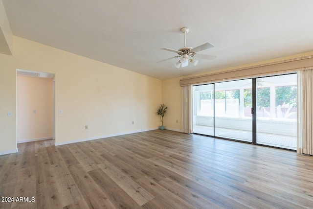 unfurnished room with light wood-type flooring, lofted ceiling, and ceiling fan