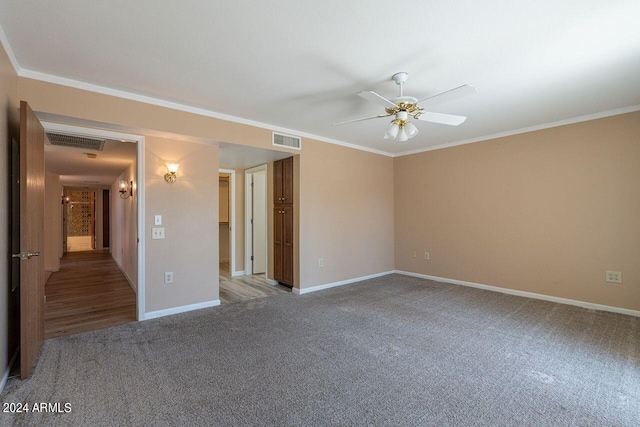 carpeted empty room with ceiling fan and crown molding