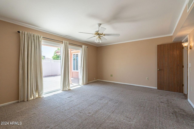 carpeted spare room featuring crown molding and ceiling fan