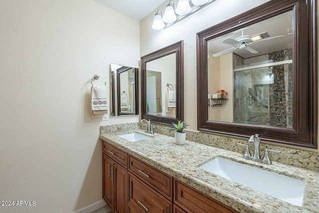 bathroom with walk in shower, vanity, and ceiling fan