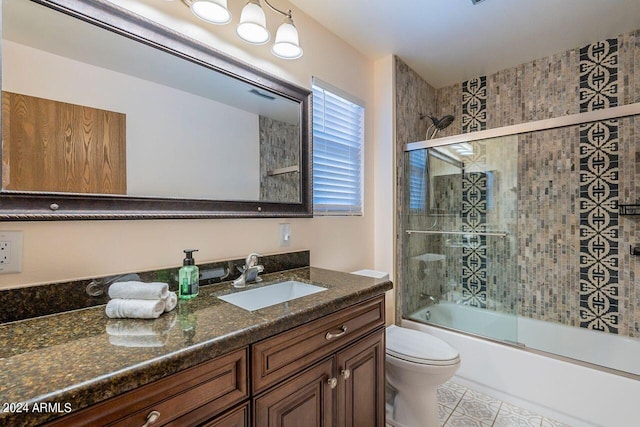 full bathroom featuring enclosed tub / shower combo, vanity, toilet, and tile patterned floors