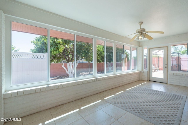 unfurnished sunroom featuring ceiling fan