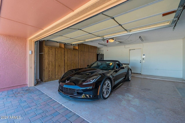 garage with a garage door opener and wood walls