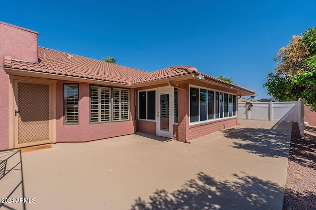 back of property with a patio