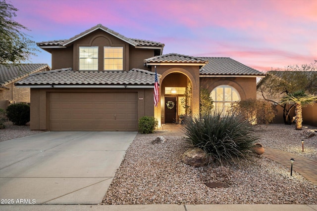 mediterranean / spanish-style home featuring a garage