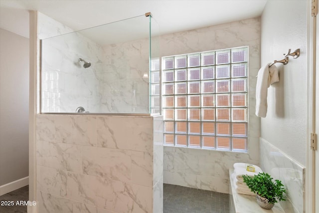 bathroom with a tile shower