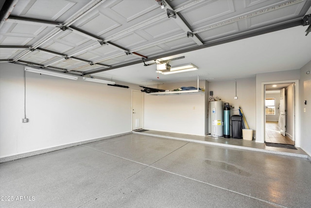 garage with water heater and a garage door opener