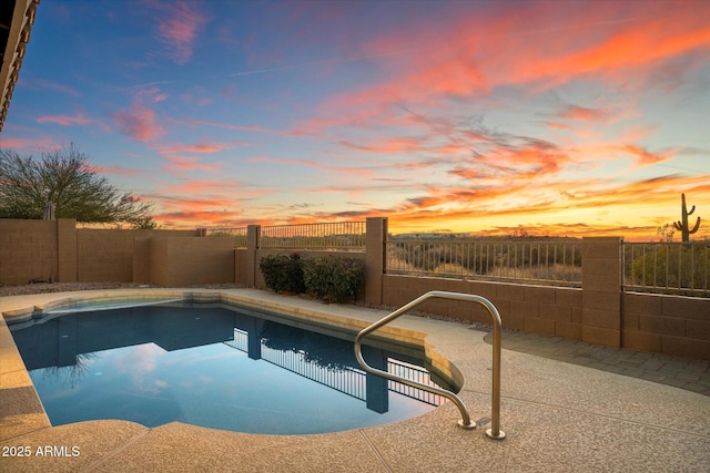 pool at dusk featuring a patio